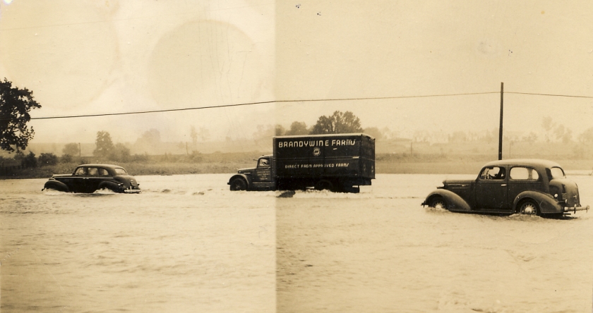 Cars and a truck navigate the Lincoln Highway during a flood in Exton, PA